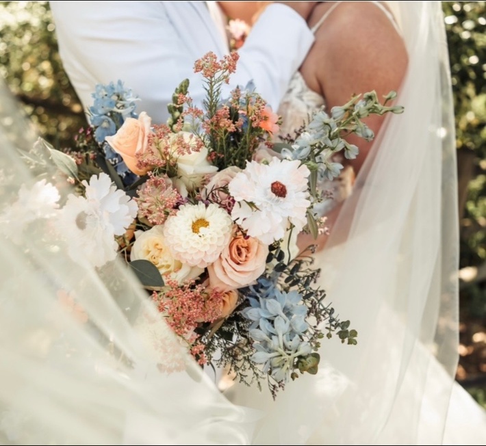 Bride and bridesmaids with white rose bouquets