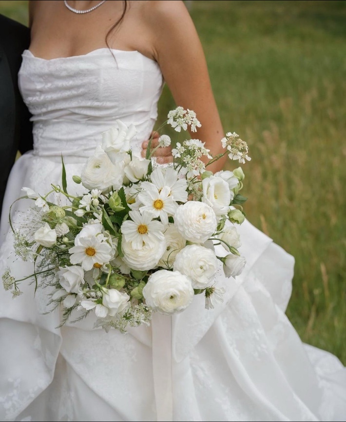 Bride holding a white floral bouquet