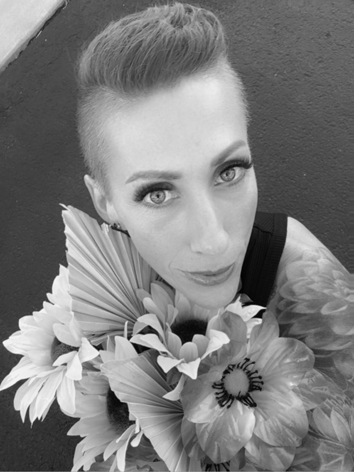 Heather Ellis with floral arrangement